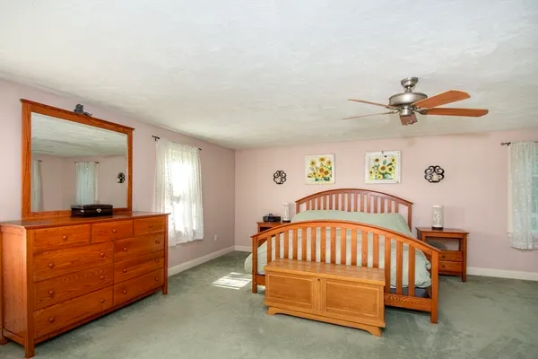 a bedroom with a bed and a dresser in it