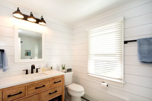 a bedroom with a bed dresser and a window