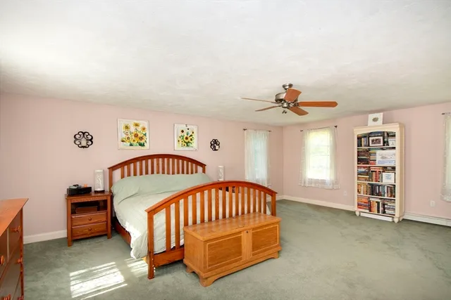 a bedroom with a bed and a book shelf