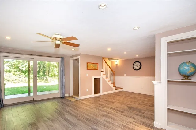 a view of a livingroom with wooden floor and window