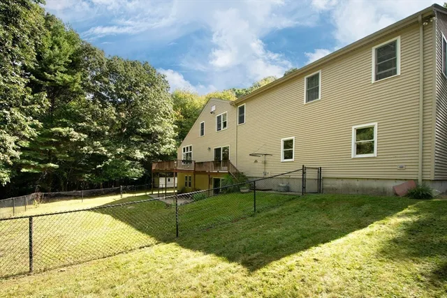 a view of a house with backyard and sitting area