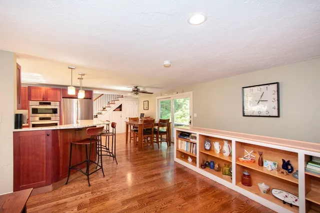 a kitchen with stainless steel appliances granite countertop wooden cabinets a sink and a large window