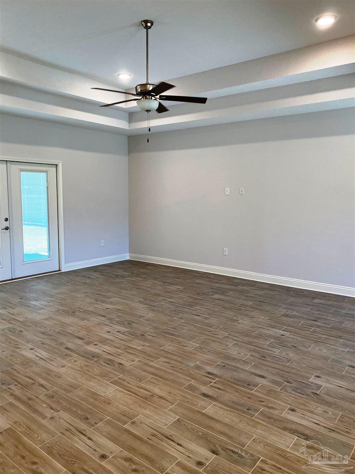 5496 South A Jones Road Milton, FL 32583 - Photo 17 of 26 Living room has a double box ceiling w/fan/light.