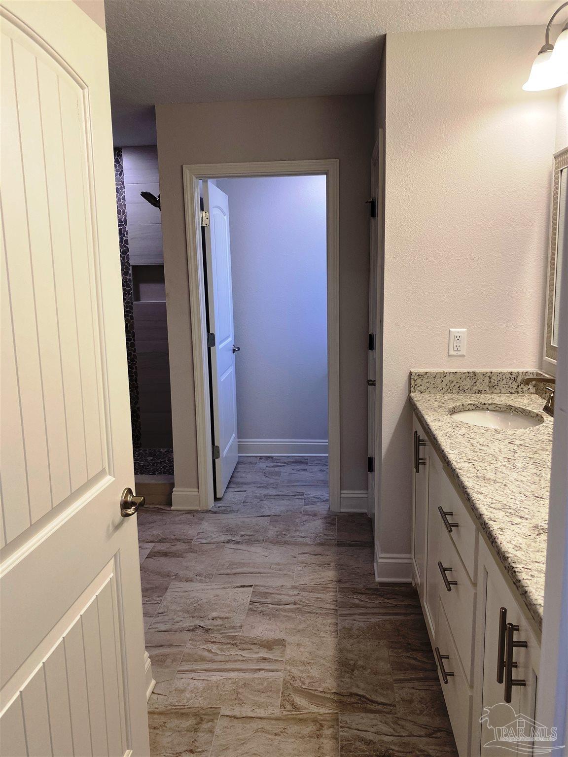 5496 South A Jones Road Milton, FL 32583 - Photo 20 of 26 Master bath features a fiberglass shower w/seat.
