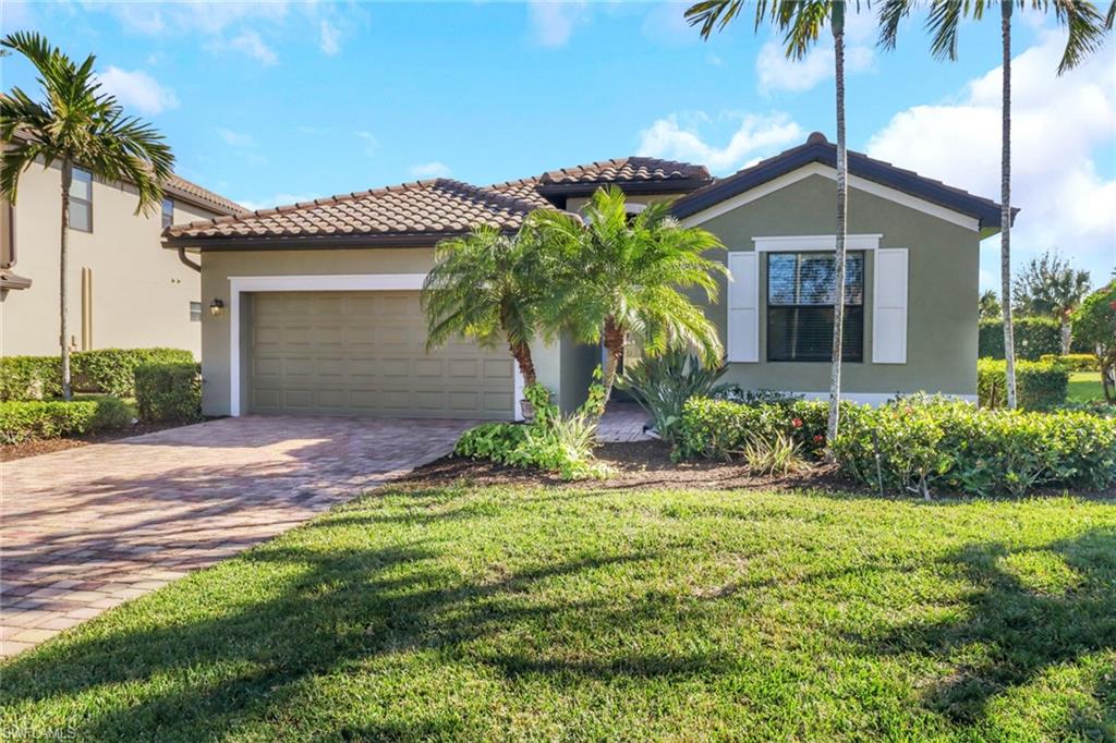 13527 San Georgio Drive Estero, FL 33928 - Photo 1 of 49 a front view of a house with a yard