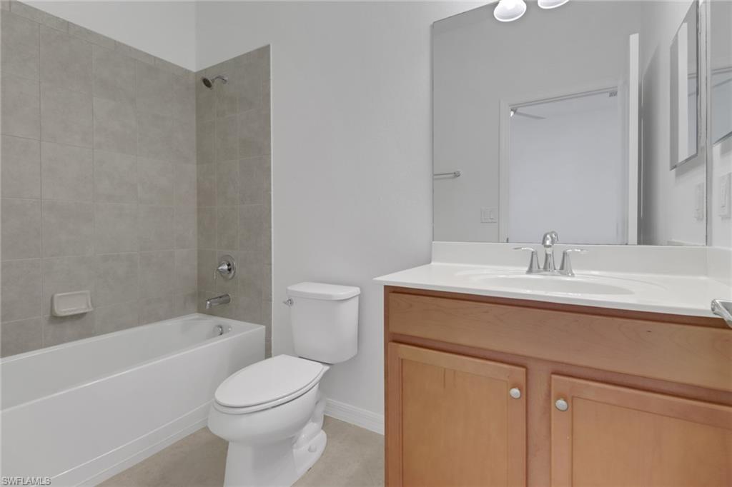 13527 San Georgio Drive Estero, FL 33928 - Photo 16 of 49 a bathroom with a sink toilet and bathtub