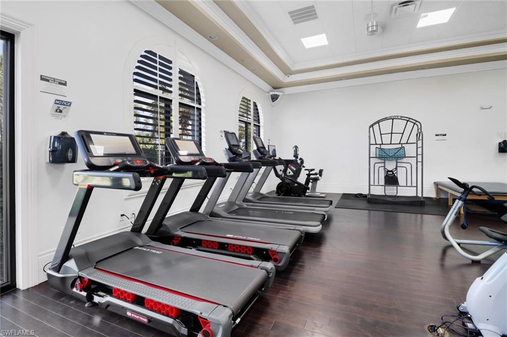 13527 San Georgio Drive Estero, FL 33928 - Photo 29 of 49 a room with gym equipment and wooden floor