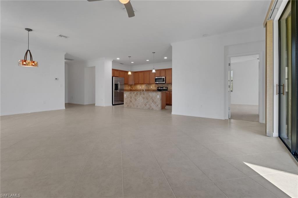 13527 San Georgio Drive Estero, FL 33928 - Photo 8 of 49 a view of a kitchen and a refrigerator