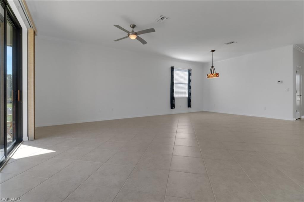 13527 San Georgio Drive Estero, FL 33928 - Photo 9 of 49 an empty room with a empty space and windows