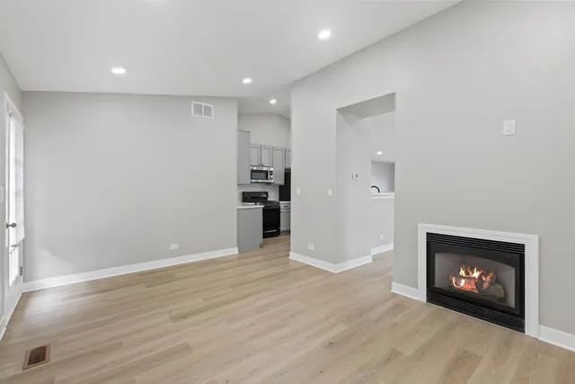a view of an empty room with a fireplace