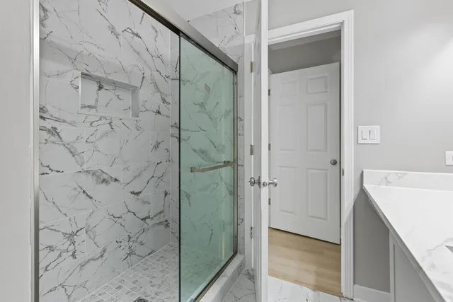 a bathroom with a shower and a sink