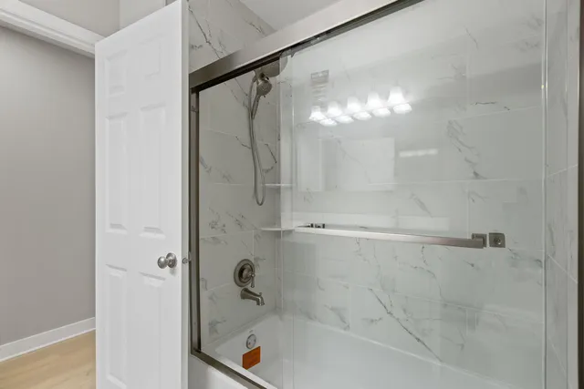 a bathroom with a bathtub and a shower