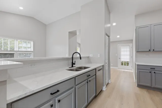 a kitchen with sink and window