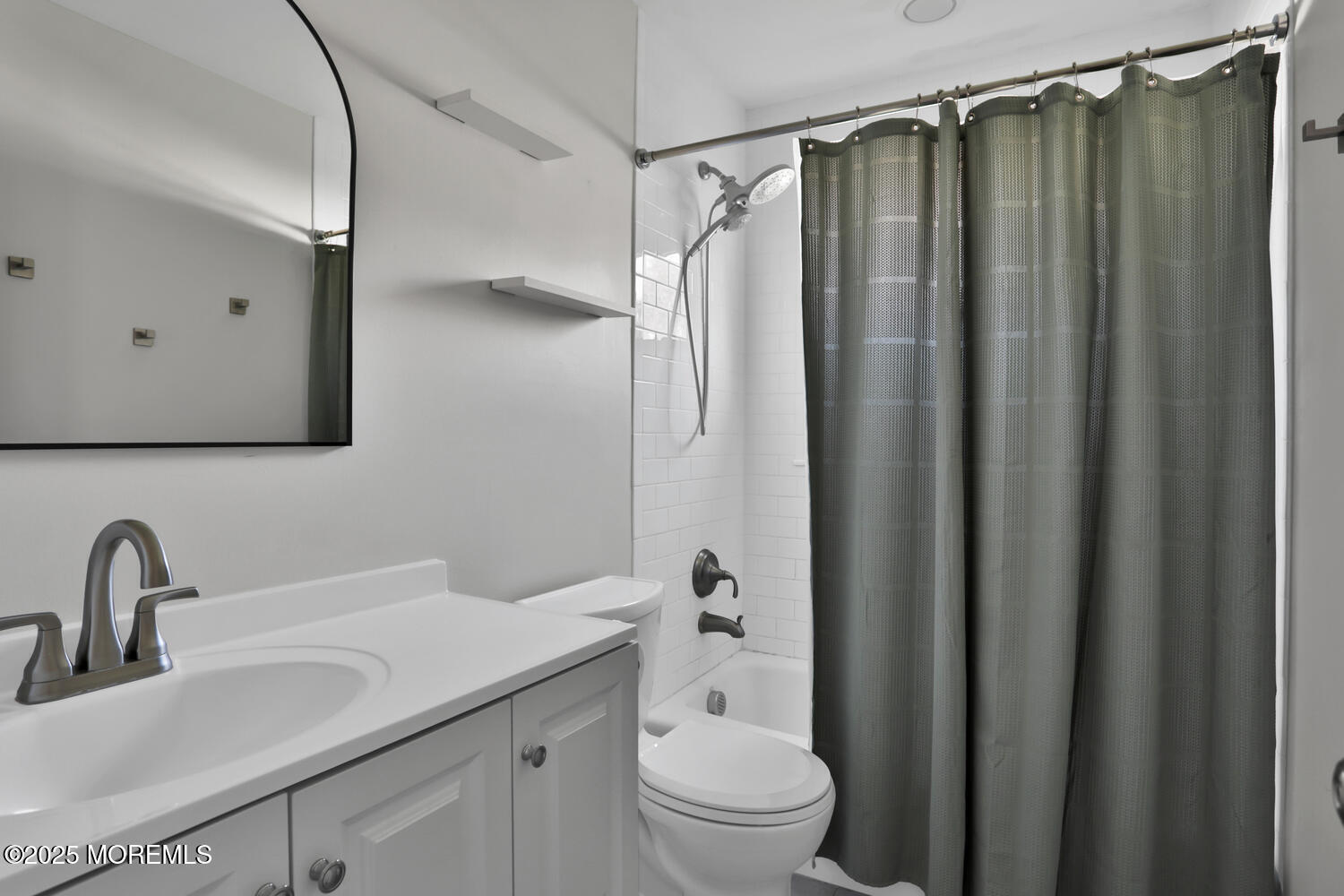 1214 Crosby Road Spring Lake Heights, NJ 07762 - Photo 12 of 32 a bathroom with a shower curtain a sink and a mirror