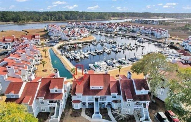 4396 Baldwin Avenue, Unit 82 Little River, SC 29566 - Photo 28 of 35 Aerial view of numerous boat docks and a nearby body of water