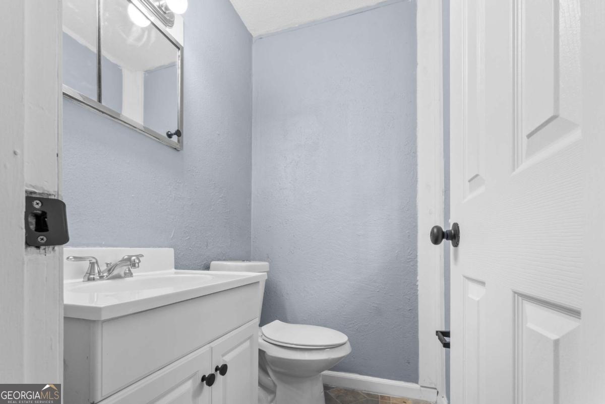 320 West Whatley Street Pooler, GA 31322 - Photo 19 of 34 a bathroom with a sink toilet and a mirror