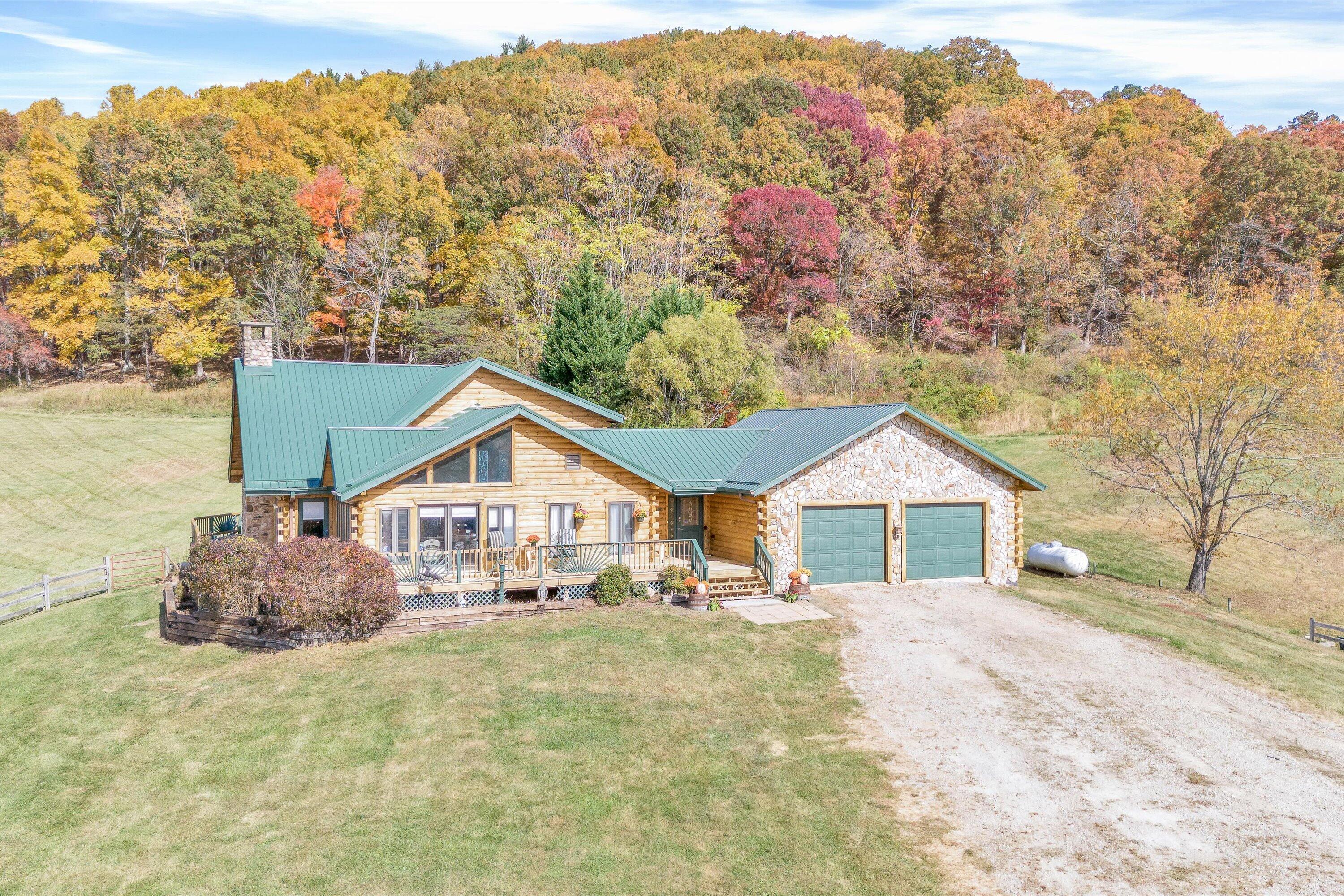765 Algoma Road Callaway, VA 24067 - Photo 52 of 61 a front view of a house with a yard and mountain view in back