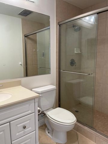 a bathroom with a shower a toilet and a sink