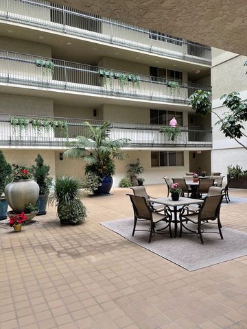a view of a chairs and table in the balcony