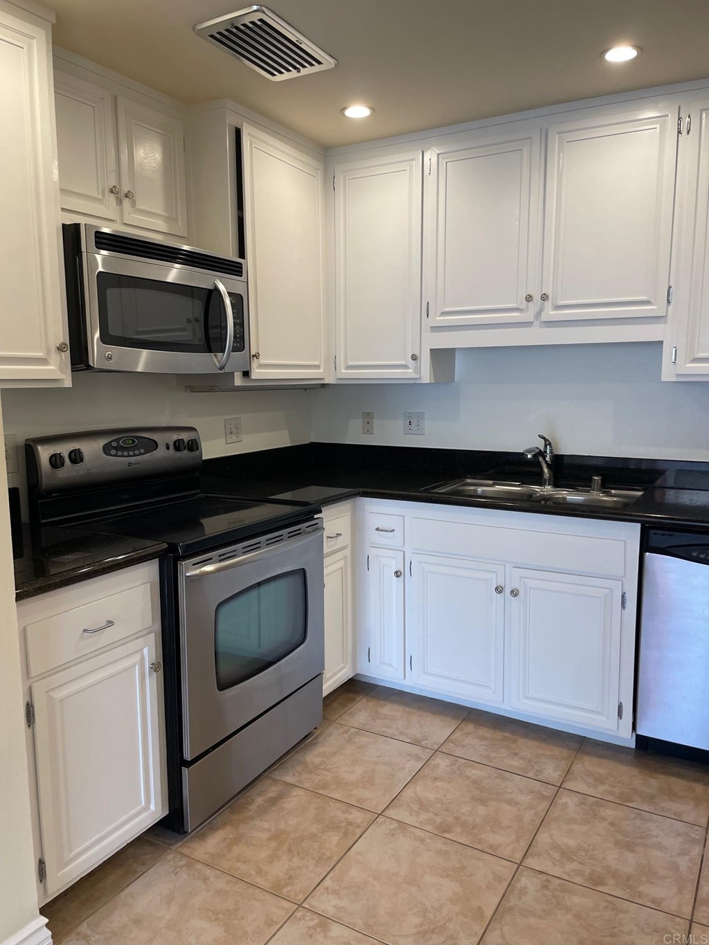 7811 Eads Avenue, Unit 307 La Jolla, CA 92037 - Photo 3 of 17 a kitchen with granite countertop white cabinets white stainless steel appliances and a sink