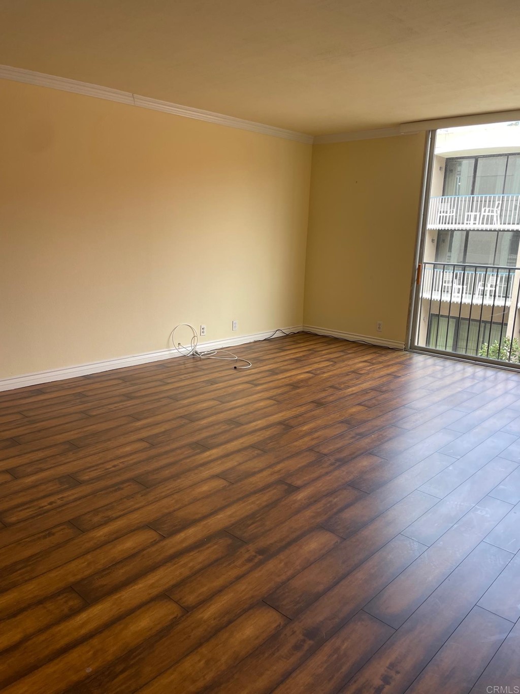 7811 Eads Avenue, Unit 307 La Jolla, CA 92037 - Photo 10 of 17 a view of an empty room with wooden floor and a window