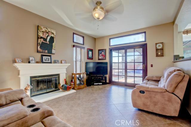 2700 Amber Circle Corona, CA 92882 - Photo 11 of 35 a living room with furniture a fireplace and a flat screen tv