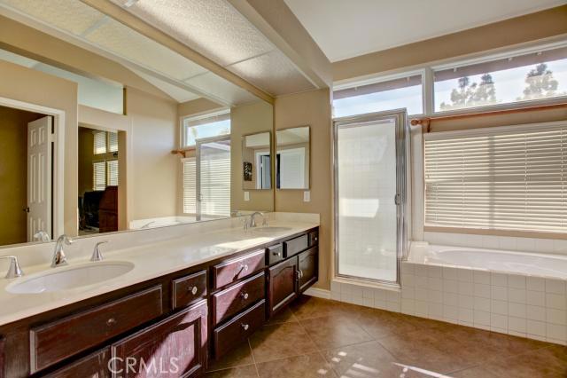 2700 Amber Circle Corona, CA 92882 - Photo 23 of 35 a bathroom with a granite countertop sink and a mirror
