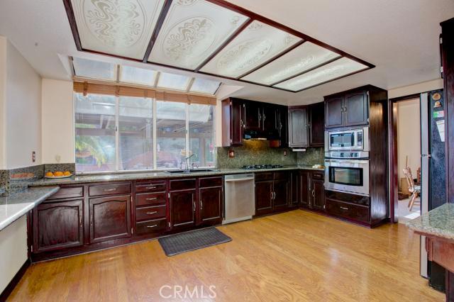 2700 Amber Circle Corona, CA 92882 - Photo 9 of 35 a kitchen with stainless steel appliances granite countertop a stove a sink and a refrigerator