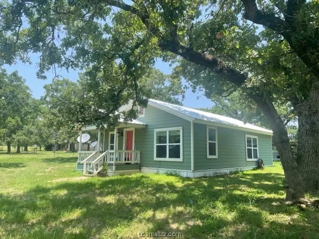 a view of a house with a backyard