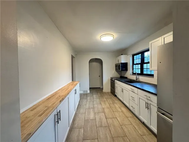 a view of a livingroom with a fireplace and wooden floor