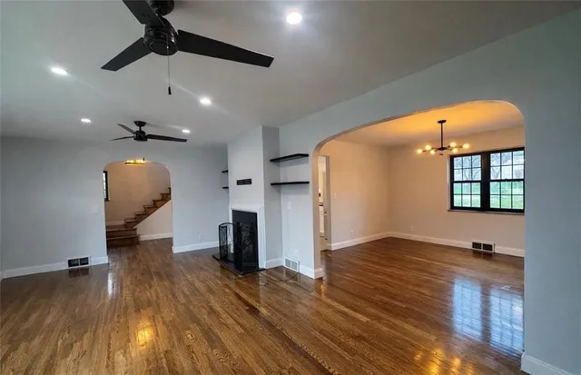 a view of entryway and hall with wooden floor