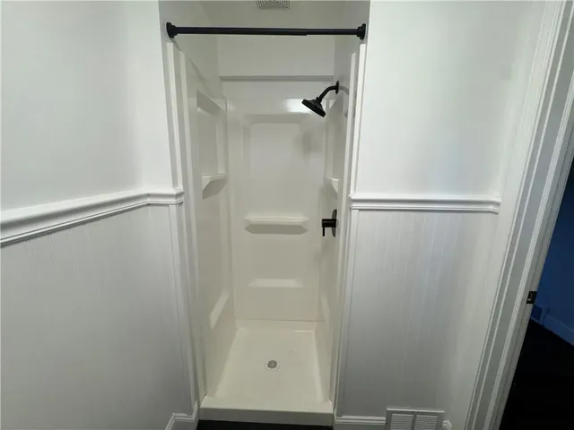 an empty room with a ceiling fan and a window