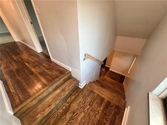 a view of an empty room with closet and a window