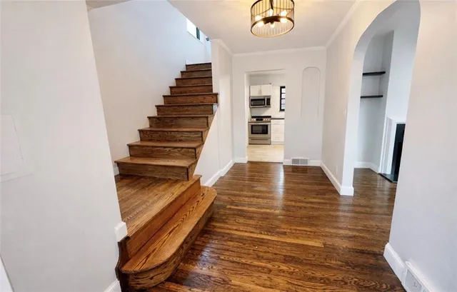 a view of a room with a window and wooden floor