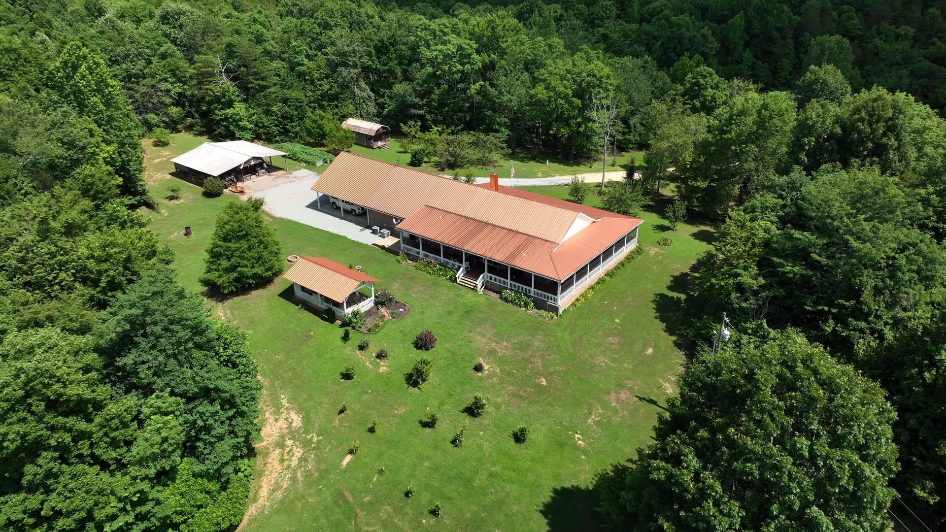 3123 Jeter Road Clifton, TN 38425 - Photo 1 of 40 an aerial view of a house