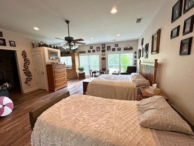 3123 Jeter Road Clifton, TN 38425 - Photo 22 of 40 a bedroom with a bed ceiling fan and a wooden floor