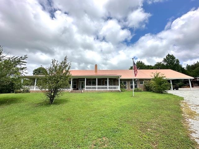 3123 Jeter Road Clifton, TN 38425 - Photo 3 of 40 a front view of a house with a yard and trees