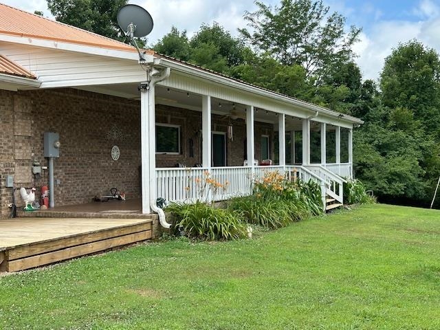 3123 Jeter Road Clifton, TN 38425 - Photo 31 of 40 a view of a house with backyard and sitting area