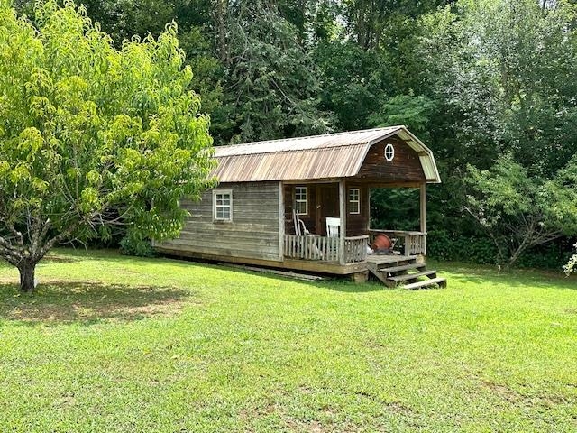 3123 Jeter Road Clifton, TN 38425 - Photo 37 of 40 a view of a house with backyard porch and sitting area