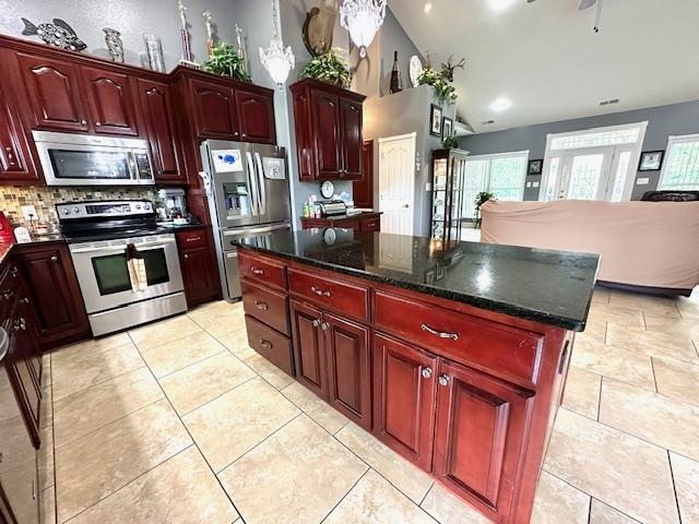 3123 Jeter Road Clifton, TN 38425 - Photo 9 of 40 a kitchen with stainless steel appliances granite countertop a stove refrigerator and microwave