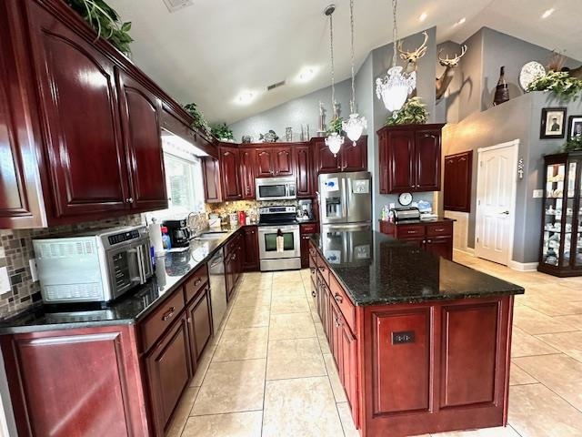 3123 Jeter Road Clifton, TN 38425 - Photo 10 of 40 a kitchen with stainless steel appliances granite countertop a stove top oven a sink dishwasher and a refrigerator