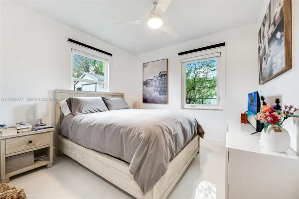 a bed room with a bed and a window