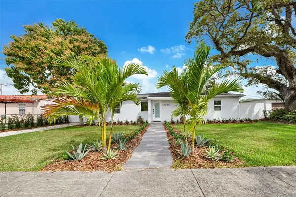 a front view of a house with garden