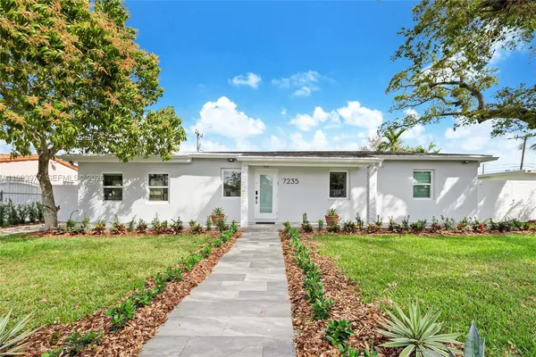 a front view of house with yard and green space
