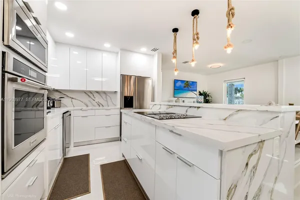 a kitchen with white cabinets and white appliances