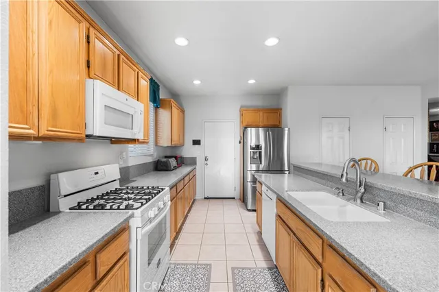 a kitchen with stainless steel appliances a sink stove and cabinets