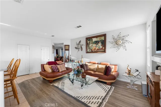 a living room with furniture a rug and a window
