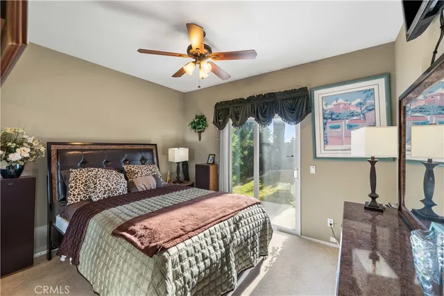 a bedroom with a large bed and a chandelier