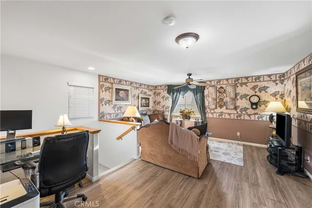a view of a workspace with furniture and wooden floor
