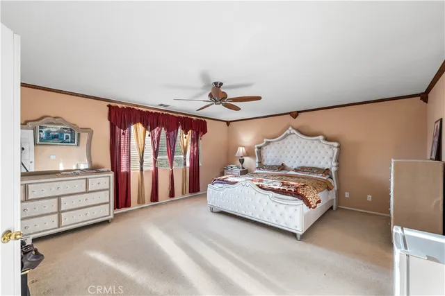 a spacious bedroom with a bed and a window